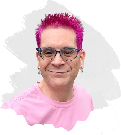 Brian, smiling, with bright pink spiked hair, teal and purple glasses, and a pink t-shirt